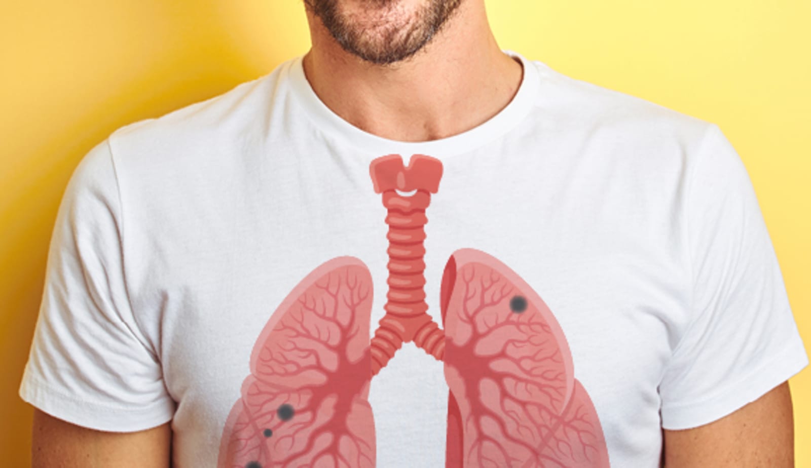 A man wearing a shirt with a graphic representation of the lungs