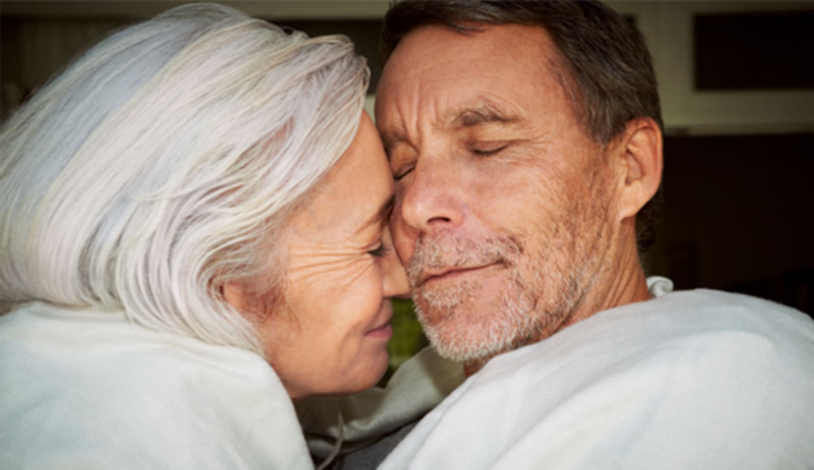 close up of a couple cuddling with their eyes closed