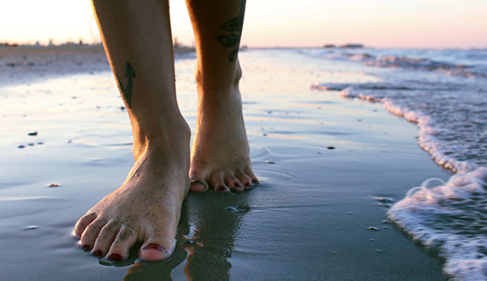 Barefoot walking in the surf at dawn