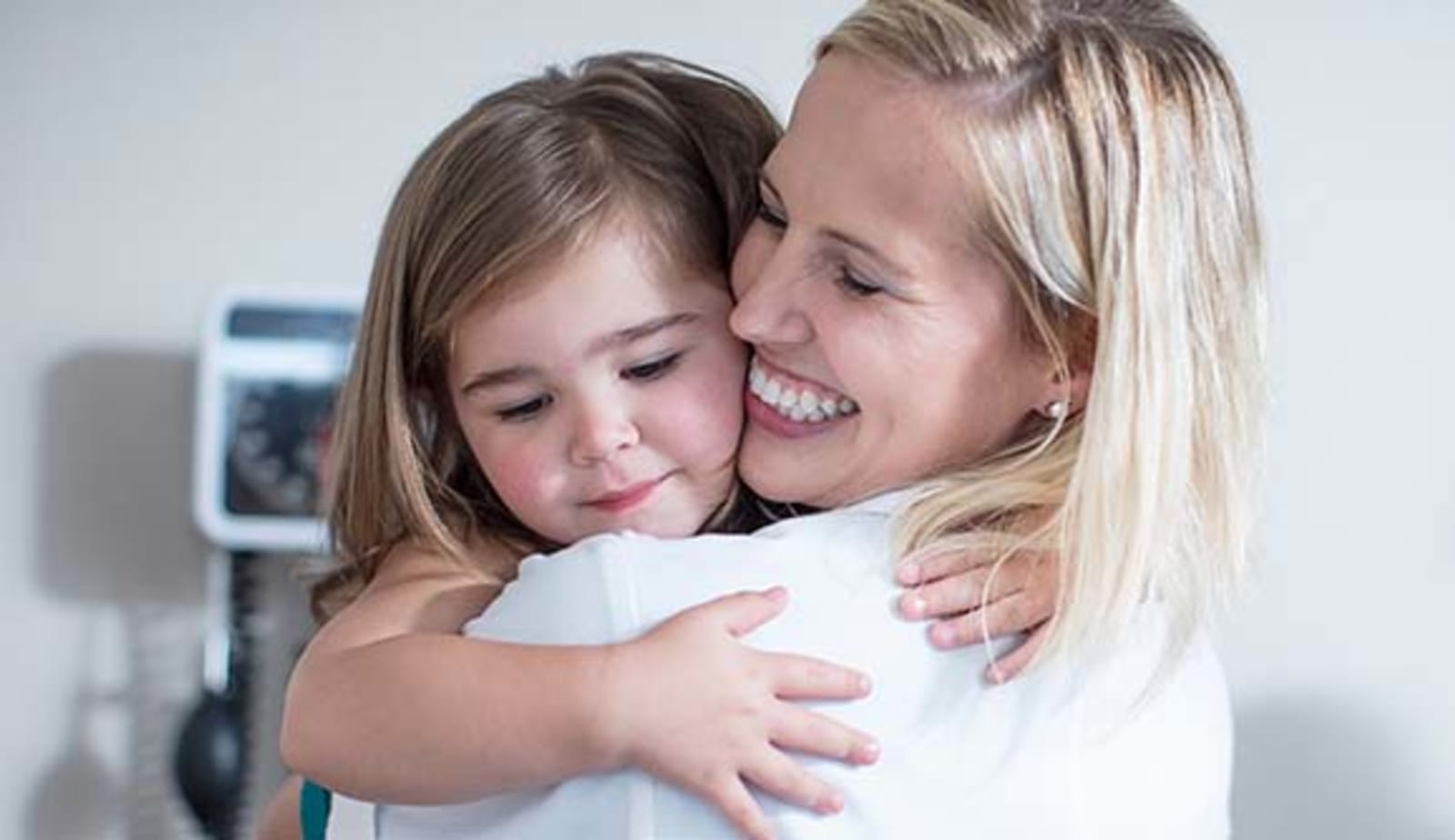 mom hugs her little girl 