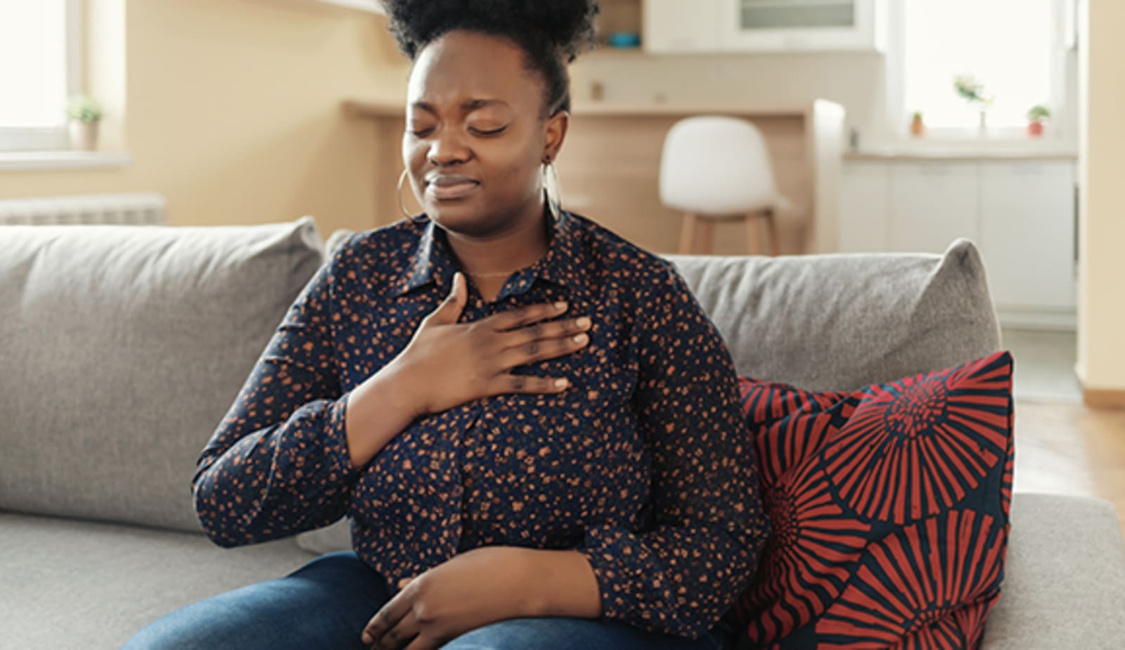 A woman clutching her chest like she is having heart palpitations