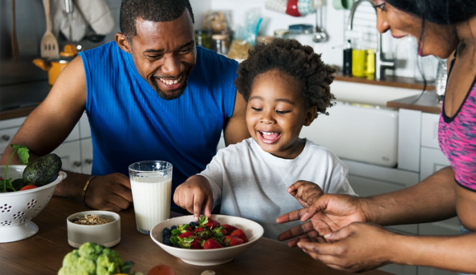 Family sitting at table with food 