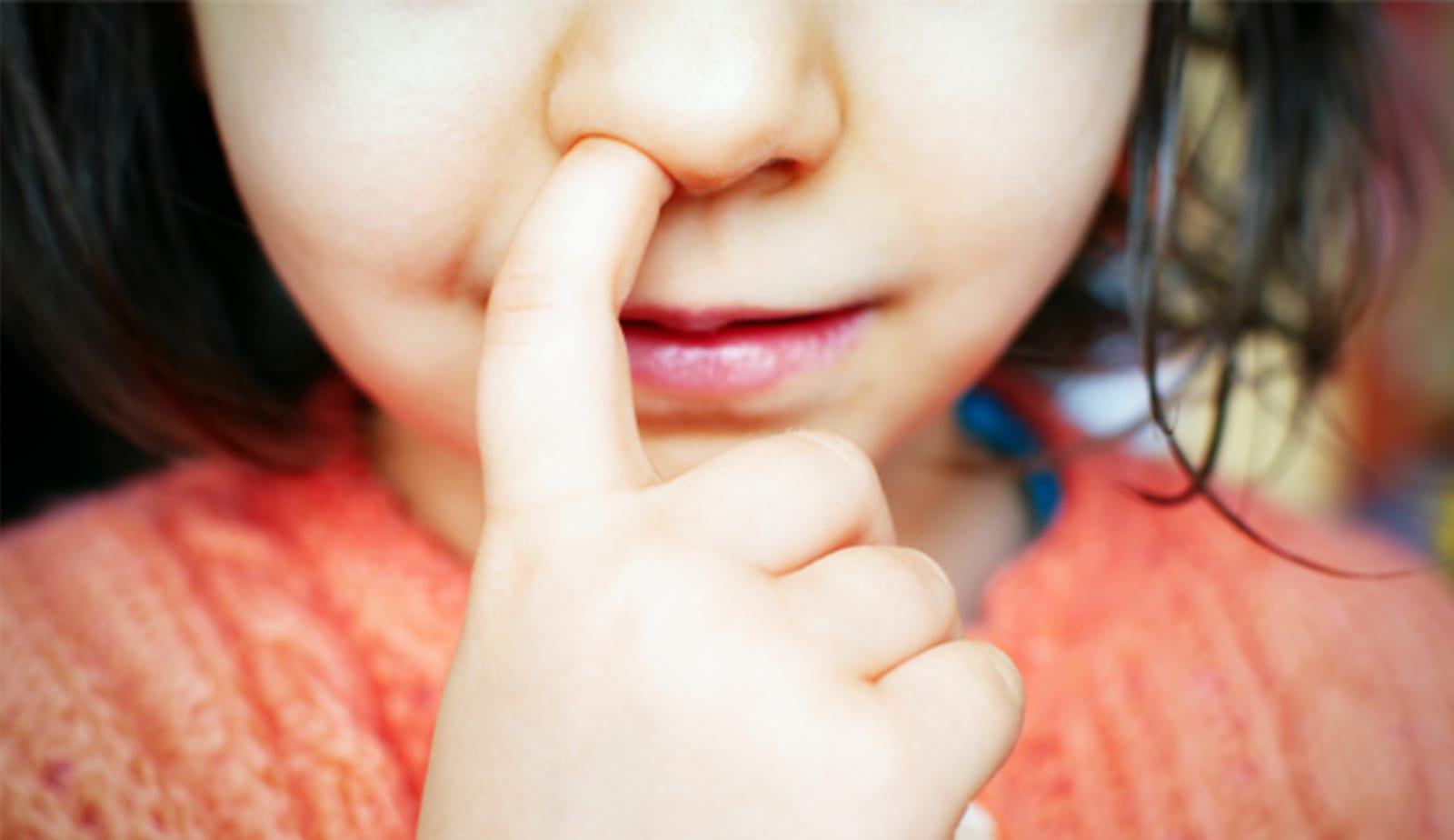 A child picking her nose