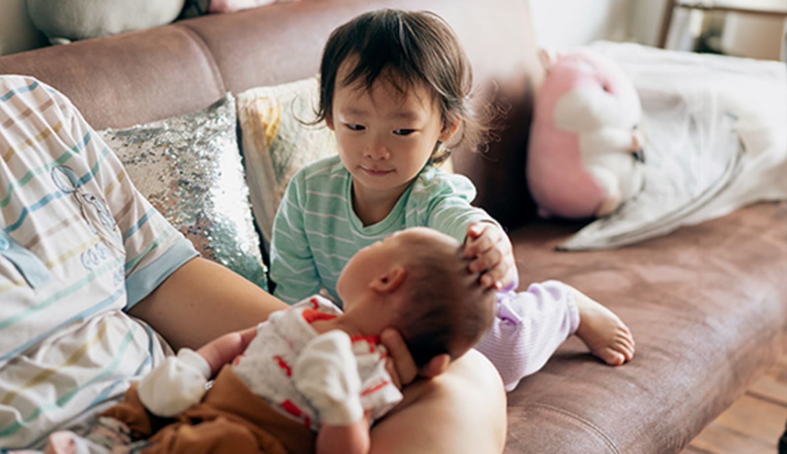 An older sibling helps with the new baby