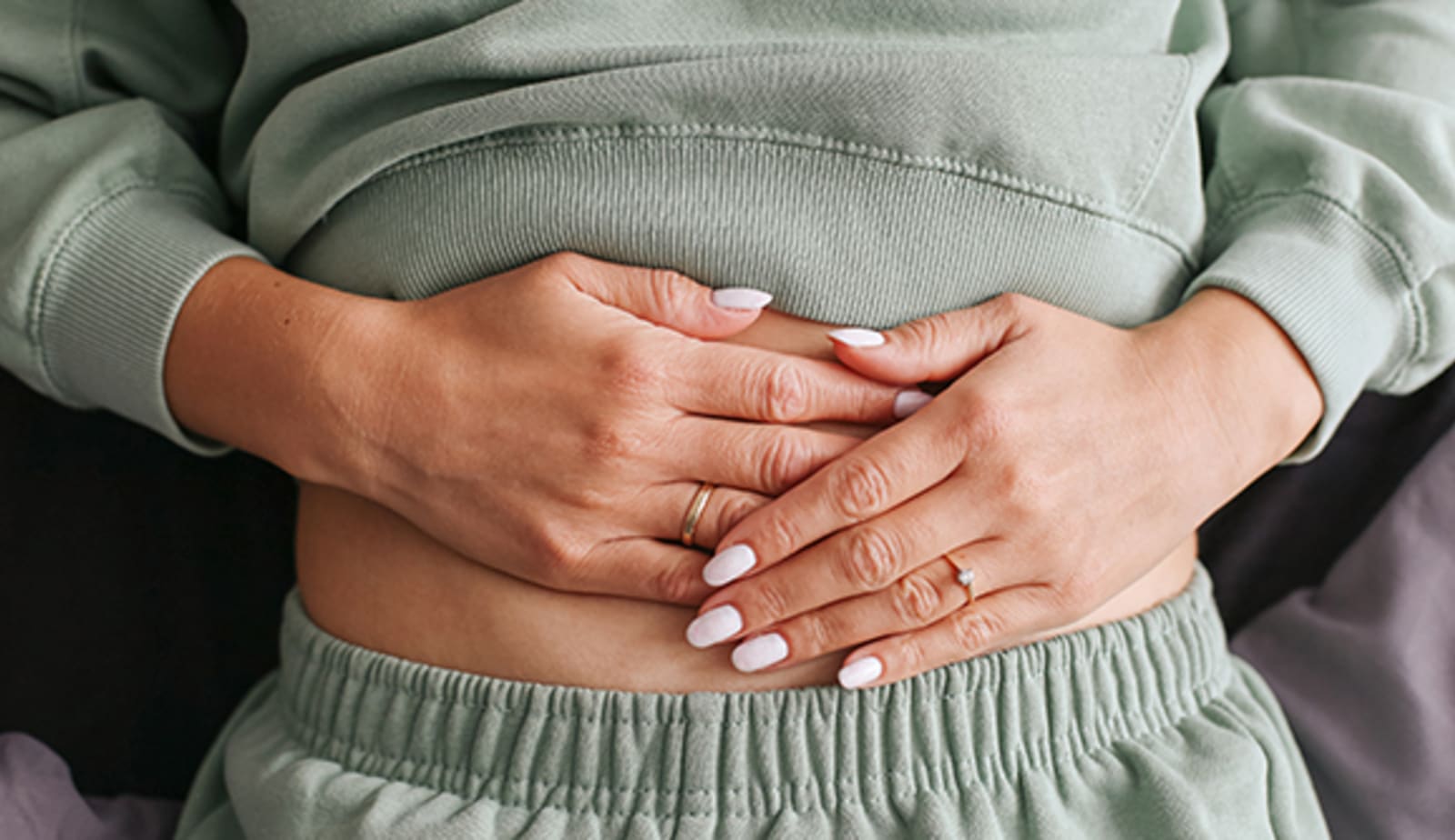 woman with hands on stomach