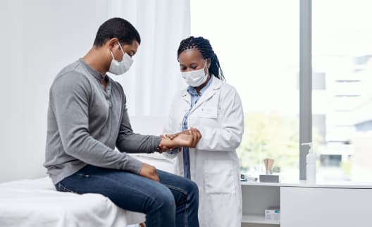 A doctor checks a patient's pulse
