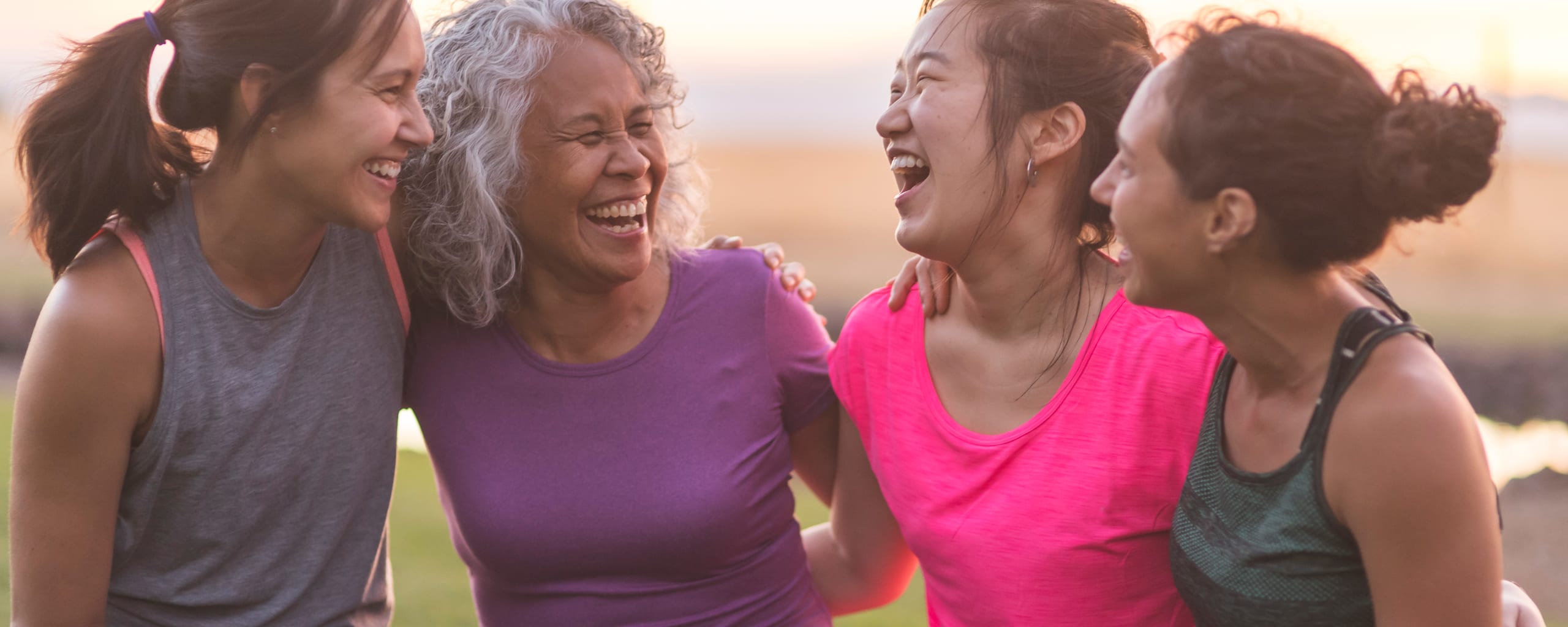 a group of middle-aged women outside laughing together after exersizing